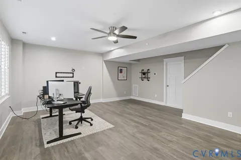 a view of a workspace with furniture and wooden floor