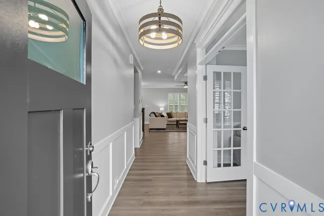a view of a hallway with wooden floor and workspace