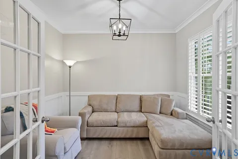 a living room with furniture and a chandelier