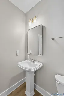 a bathroom with a sink a mirror and a toilet