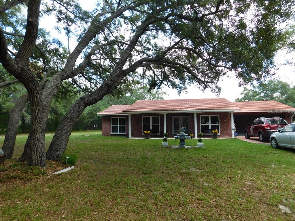 9357 Elida Road Spring Hill, FL 34608 - Photo 1 of 1 front view with wonderful southern charm
