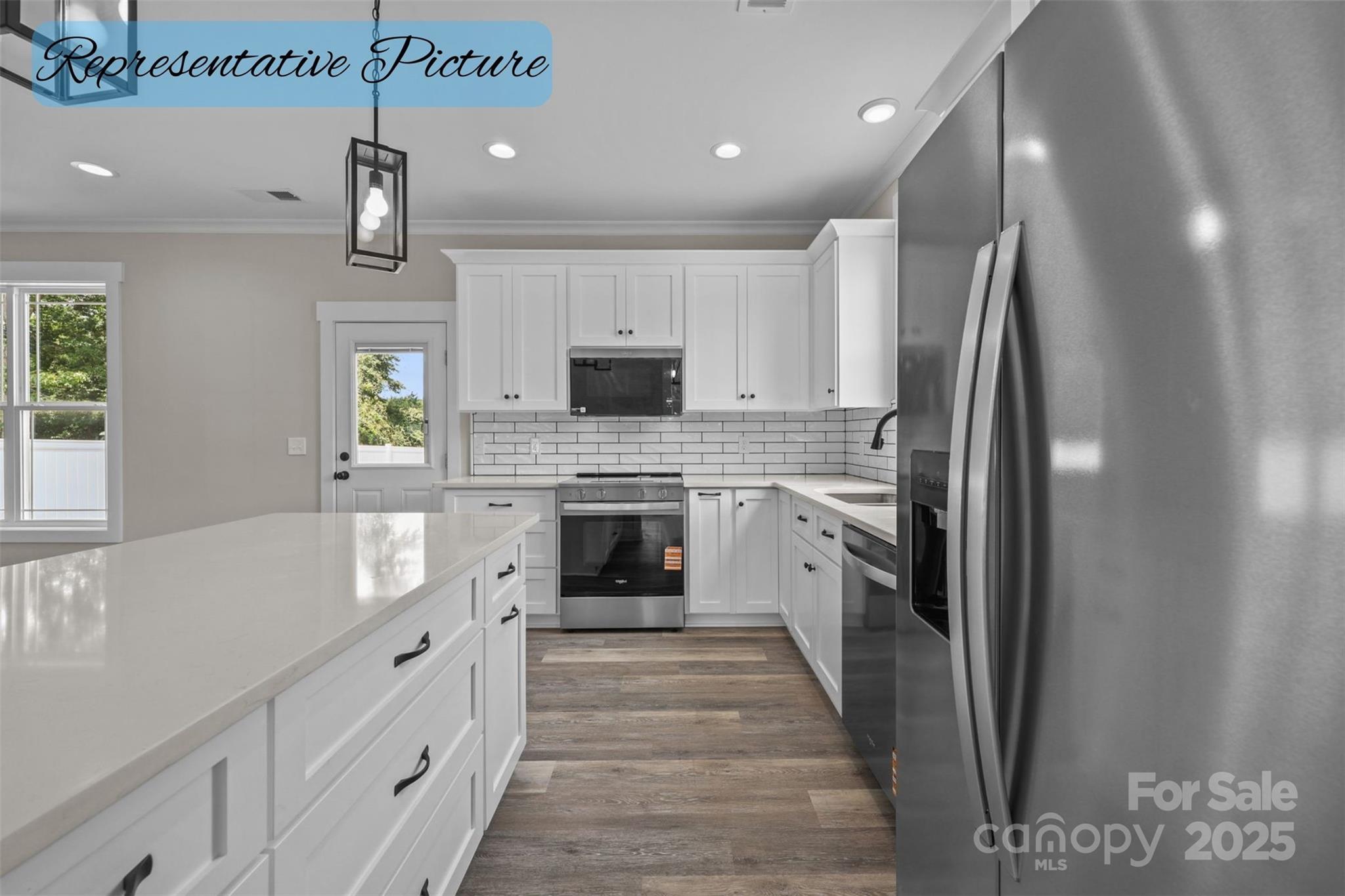 36220 Gene Road New London, NC 28127 - Photo 12 of 42 a large kitchen with stainless steel appliances granite countertop a refrigerator a sink dishwasher a stove and a dining table with wooden floor