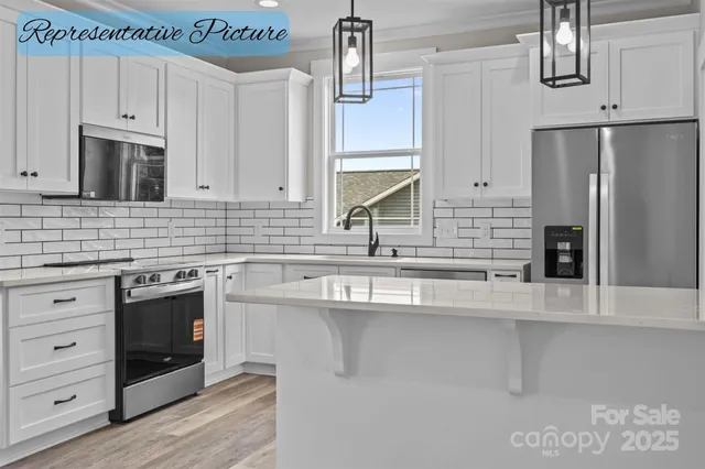 a kitchen with stainless steel appliances a sink stove and refrigerator