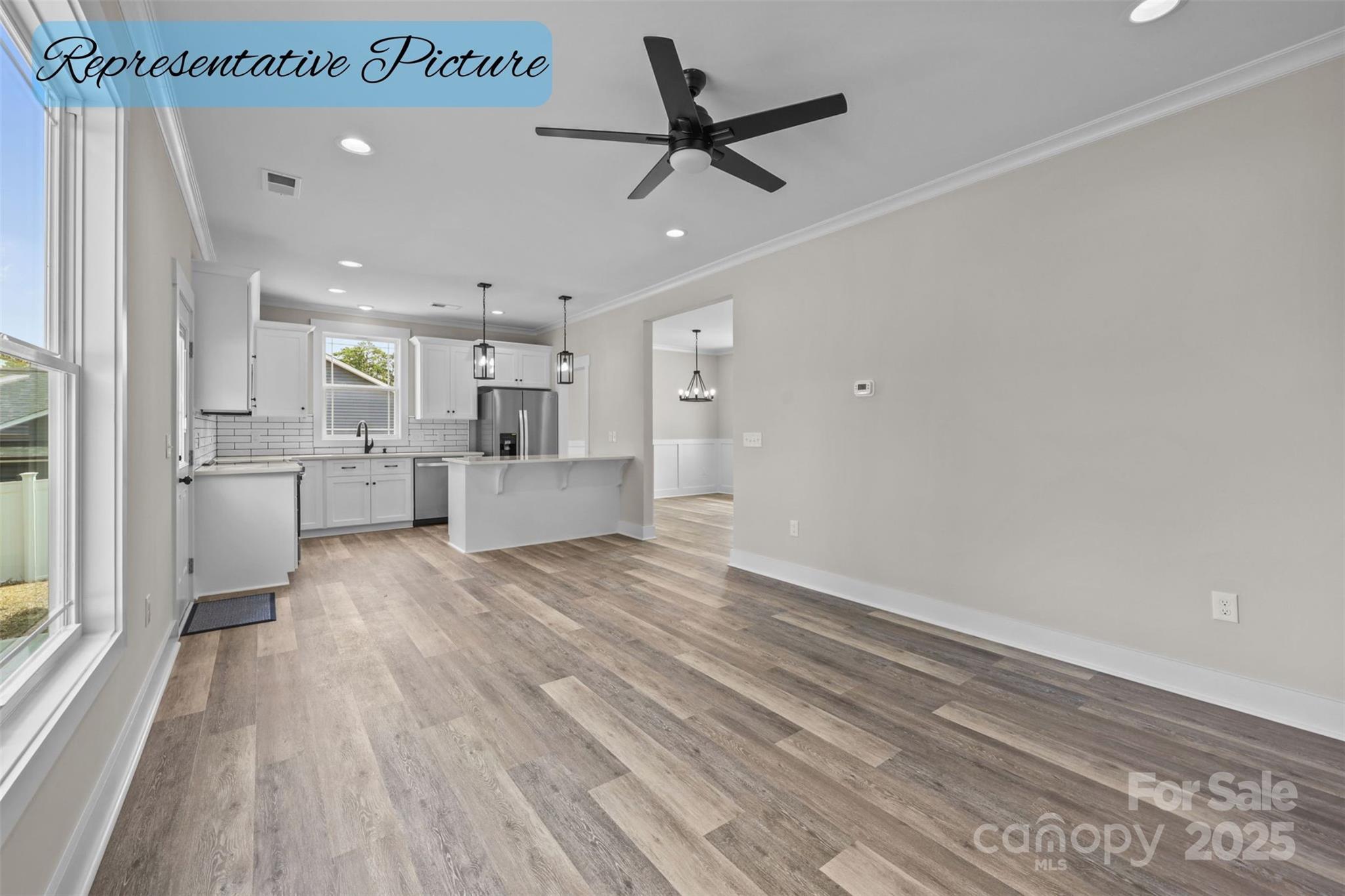 36220 Gene Road New London, NC 28127 - Photo 17 of 42 a view of a kitchen with a sink and dishwasher a refrigerator with wooden floor