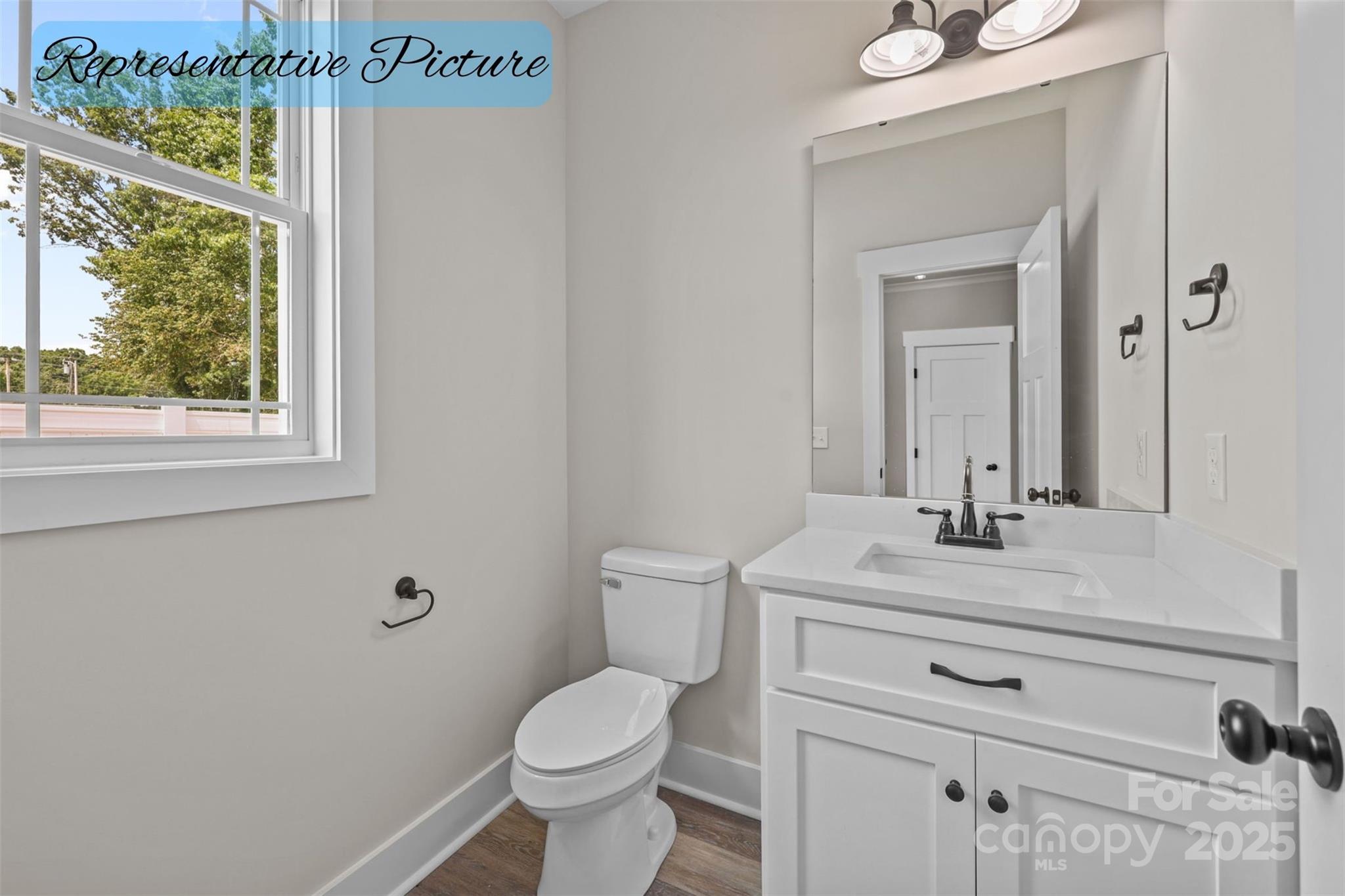 36220 Gene Road New London, NC 28127 - Photo 21 of 42 a bathroom with a sink a toilet and a mirror