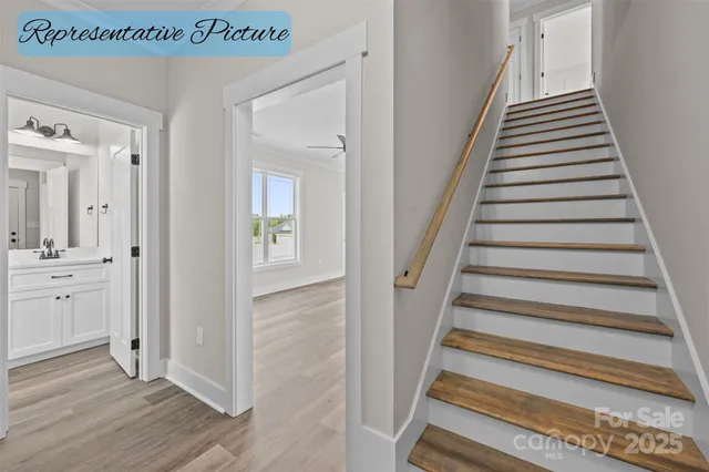 a view of a hallway with wooden floor and entryway