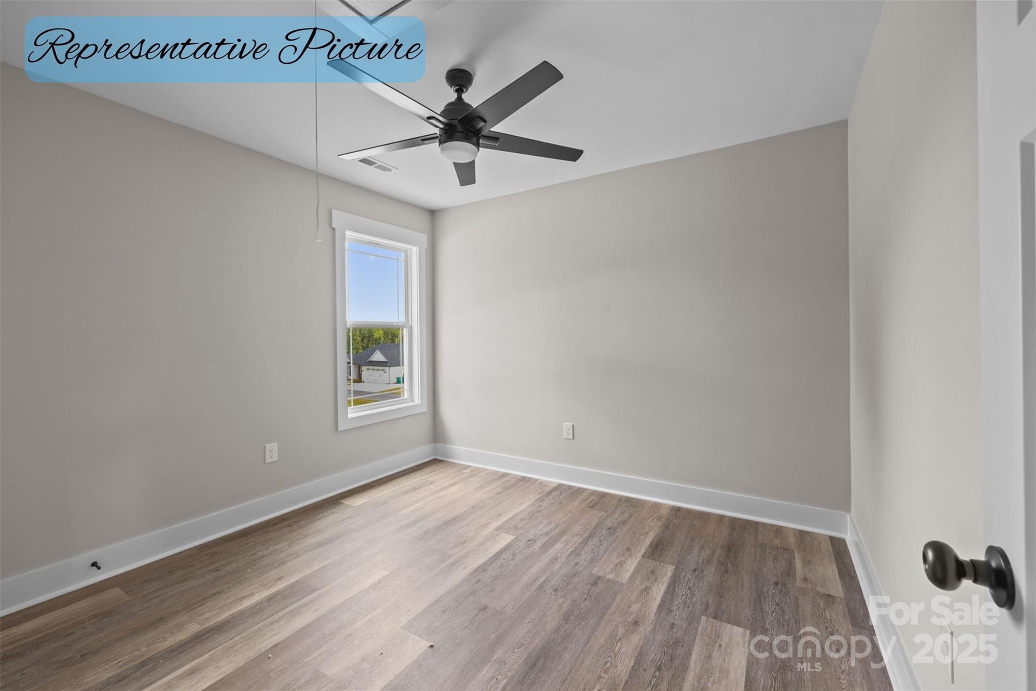 36220 Gene Road New London, NC 28127 - Photo 27 of 42 a view of an empty room with wooden floor and a window