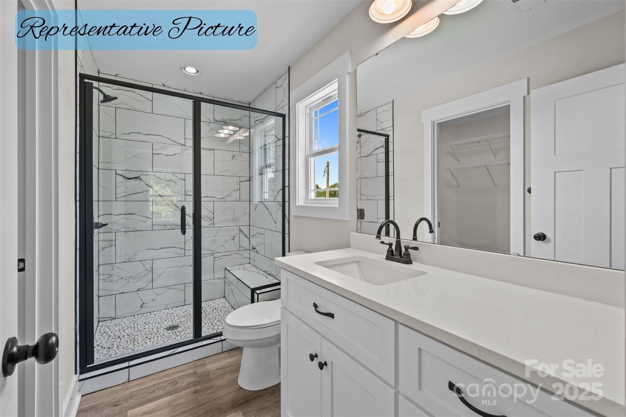 36220 Gene Road New London, NC 28127 - Photo 34 of 42 a bathroom with a shower sink vanity mirror and toilet