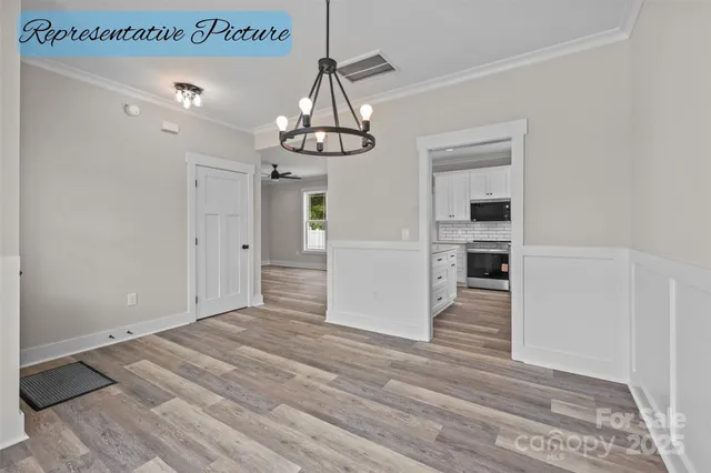 a view of a kitchen with a sink and dishwasher a refrigerator with wooden floor