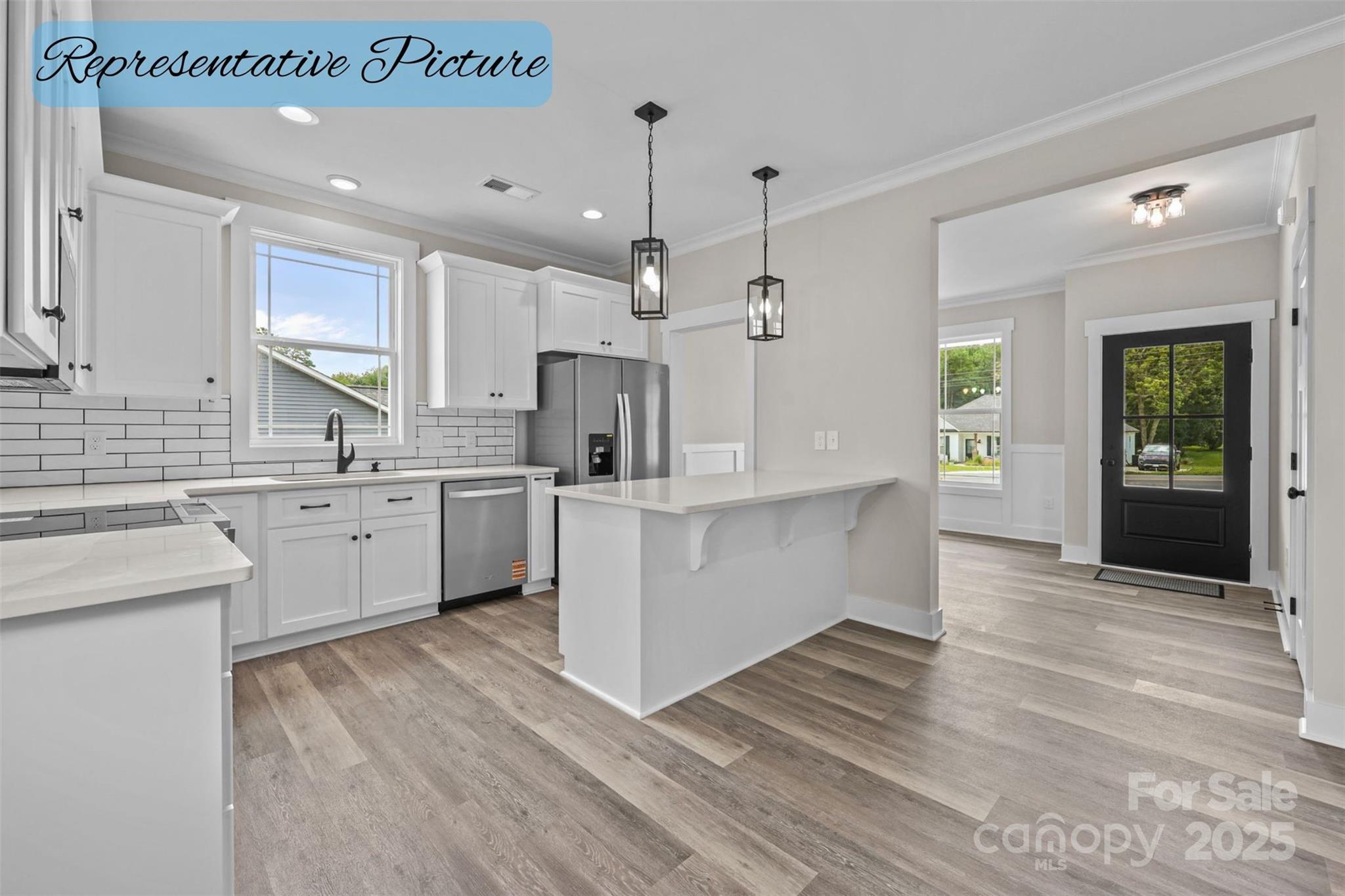 36220 Gene Road New London, NC 28127 - Photo 10 of 42 a large white kitchen with cabinets a sink and appliances