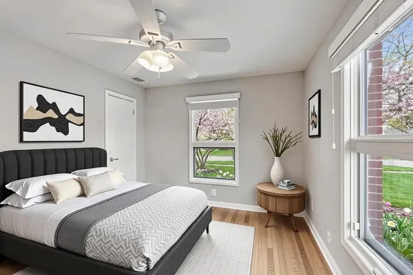 a bedroom with a bed and a painting on the wall