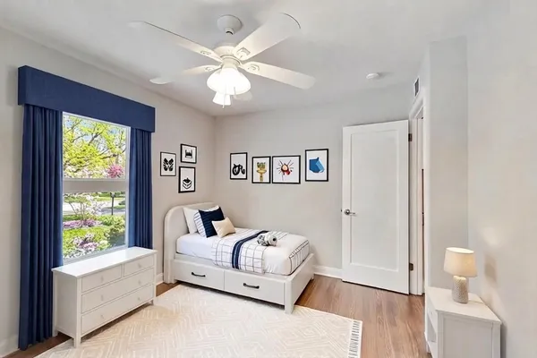 a bedroom with furniture and a large window