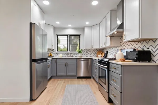 a kitchen with a sink stove and refrigerator