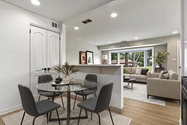 a view of a dining room with furniture and wooden floor