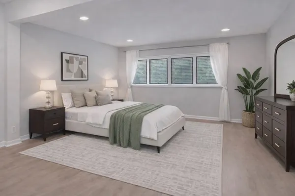 a bedroom with a large bed and a large window