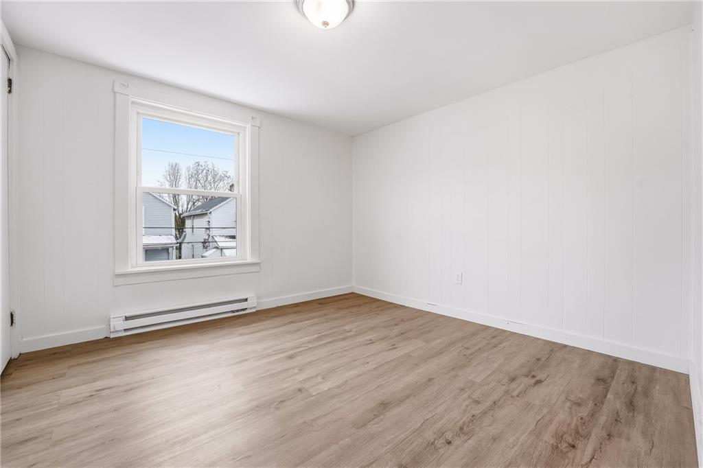 316 Mitchell Avenue Butler, PA 16001 - Photo 14 of 20 an empty room with wooden floor and windows