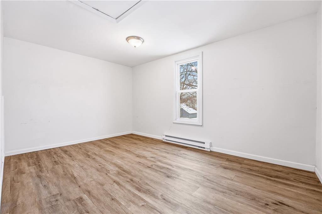 316 Mitchell Avenue Butler, PA 16001 - Photo 15 of 20 an empty room with wooden floor and windows