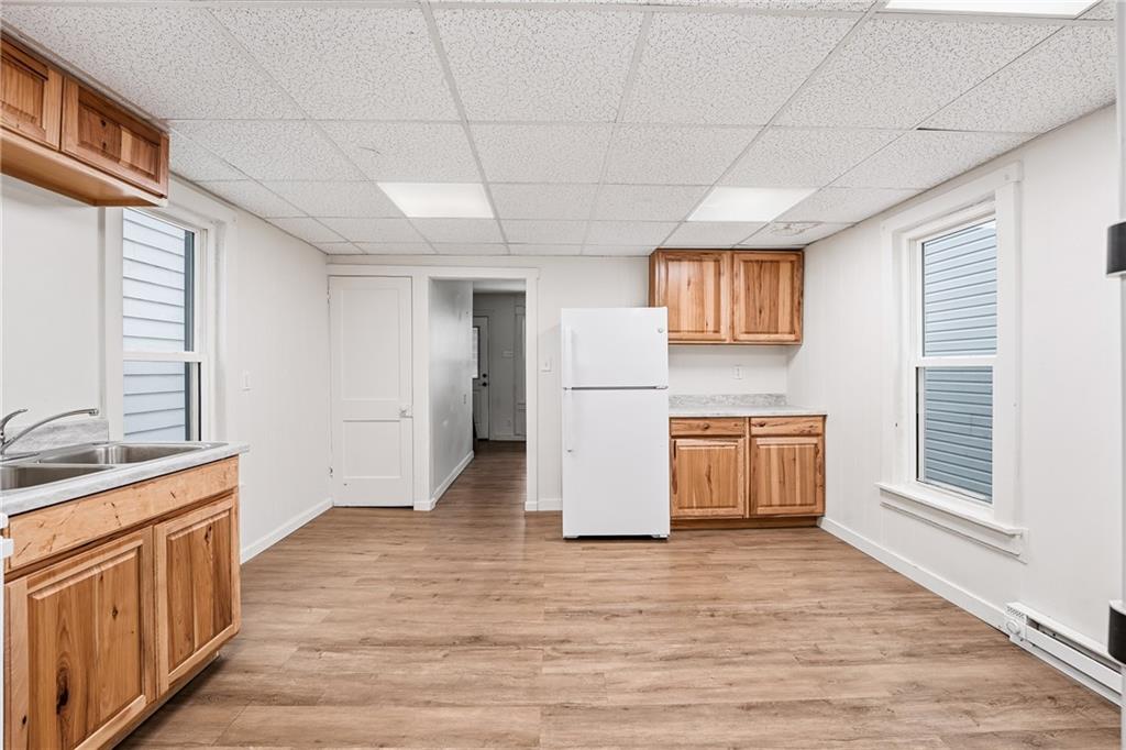 316 Mitchell Avenue Butler, PA 16001 - Photo 7 of 20 a view of a kitchen with a sink and a refrigerator