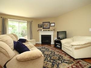 43 Foxcroft Road, Unit 103 Naperville, IL 60565 - Photo 3 of 18 a living room with furniture and a fireplace