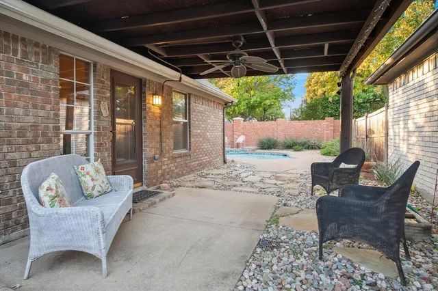 a view of a swimming pool with potted plants