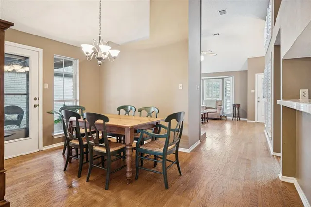a view of a dining room with furniture wooden floor and chandelier