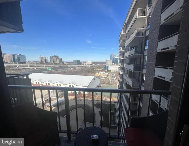 a view of a balcony with an outdoor seating