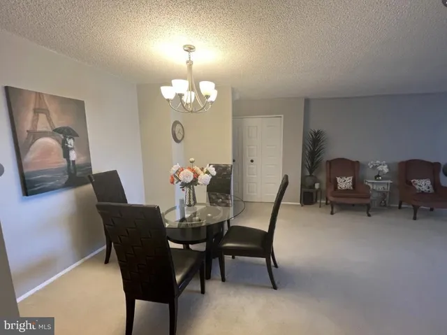 a view of a dining room with furniture and chandelier