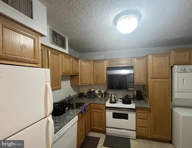 a kitchen with a stove and a refrigerator