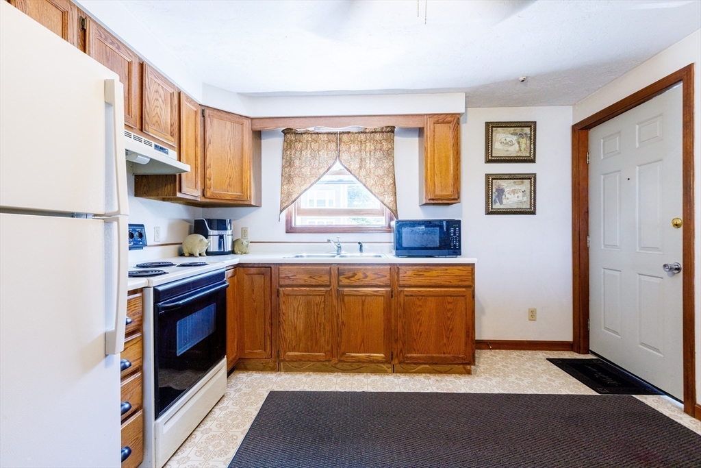 170 Perry Avenue, Unit 3A Worcester, MA 01610 - Photo 9 of 16 a kitchen with stainless steel appliances granite countertop a stove a sink and a refrigerator