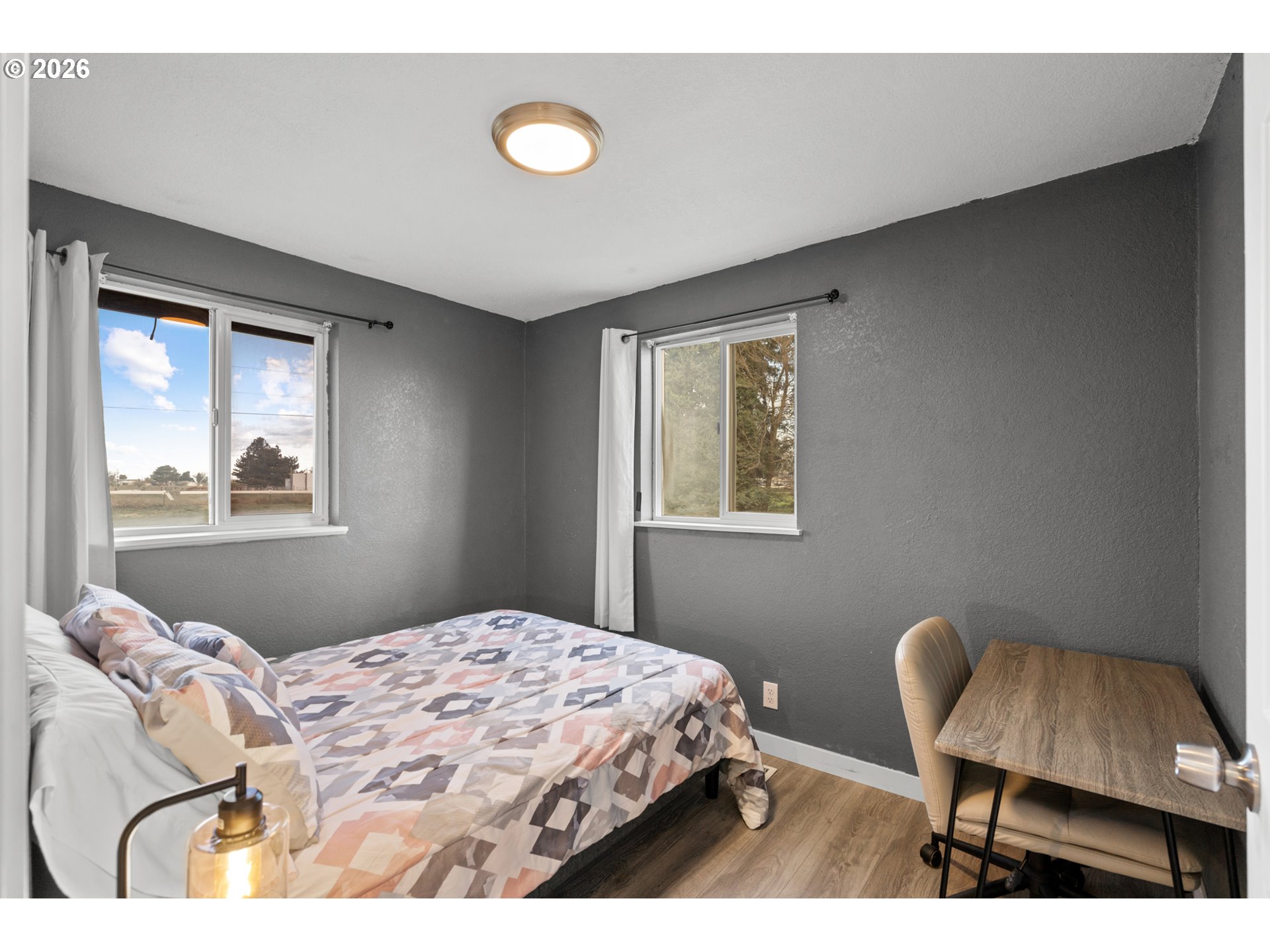 2130 Southeast 19th Street Hermiston, OR 97838 - Photo 11 of 32 a bedroom with a bed and a chair with window