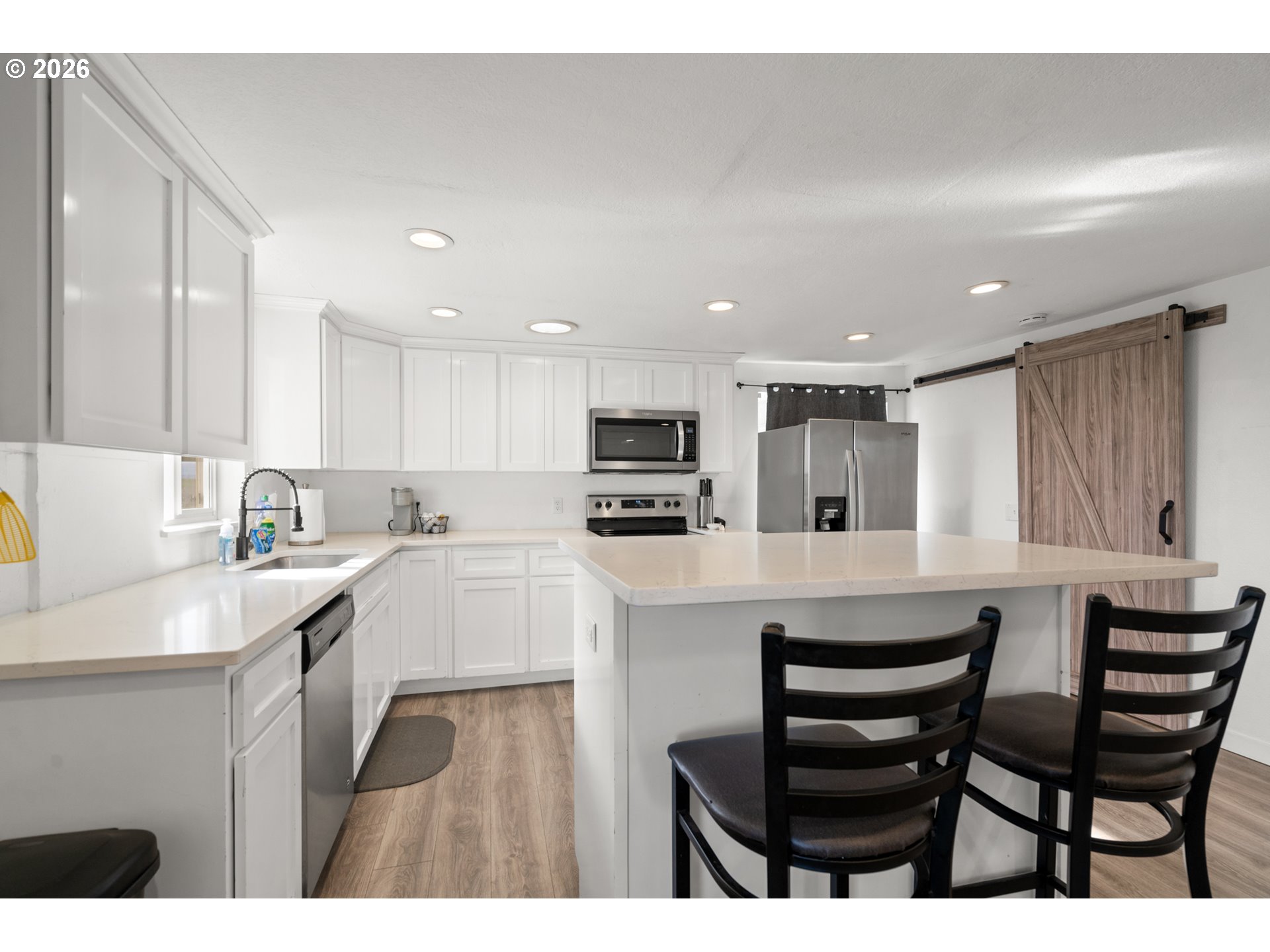 2130 Southeast 19th Street Hermiston, OR 97838 - Photo 17 of 32 a kitchen with a sink cabinets and wooden floor