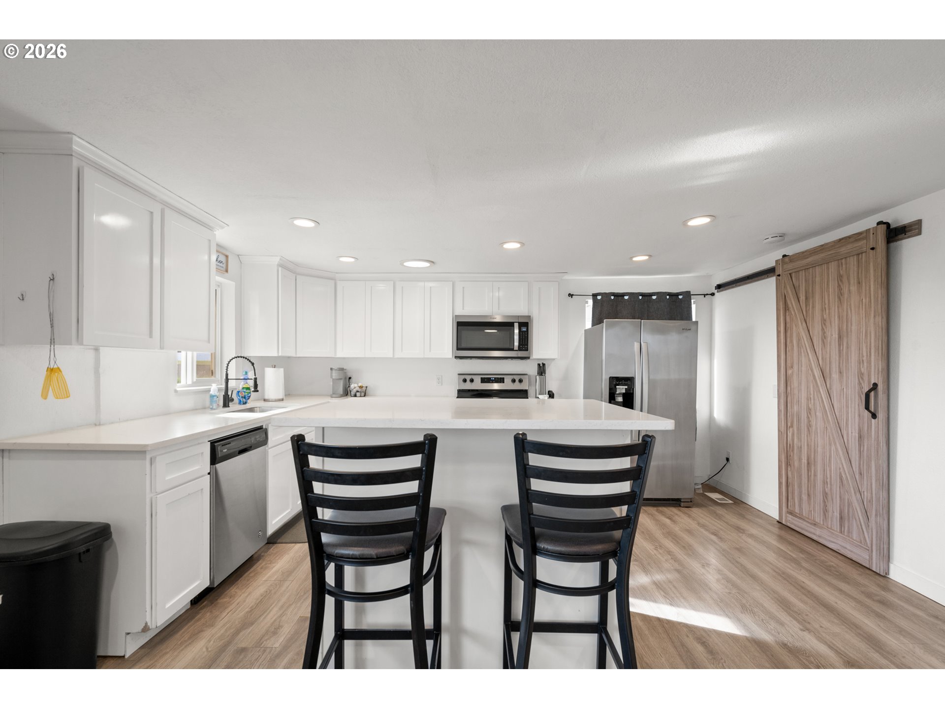 2130 Southeast 19th Street Hermiston, OR 97838 - Photo 5 of 32 a kitchen with white cabinets and stainless steel appliances
