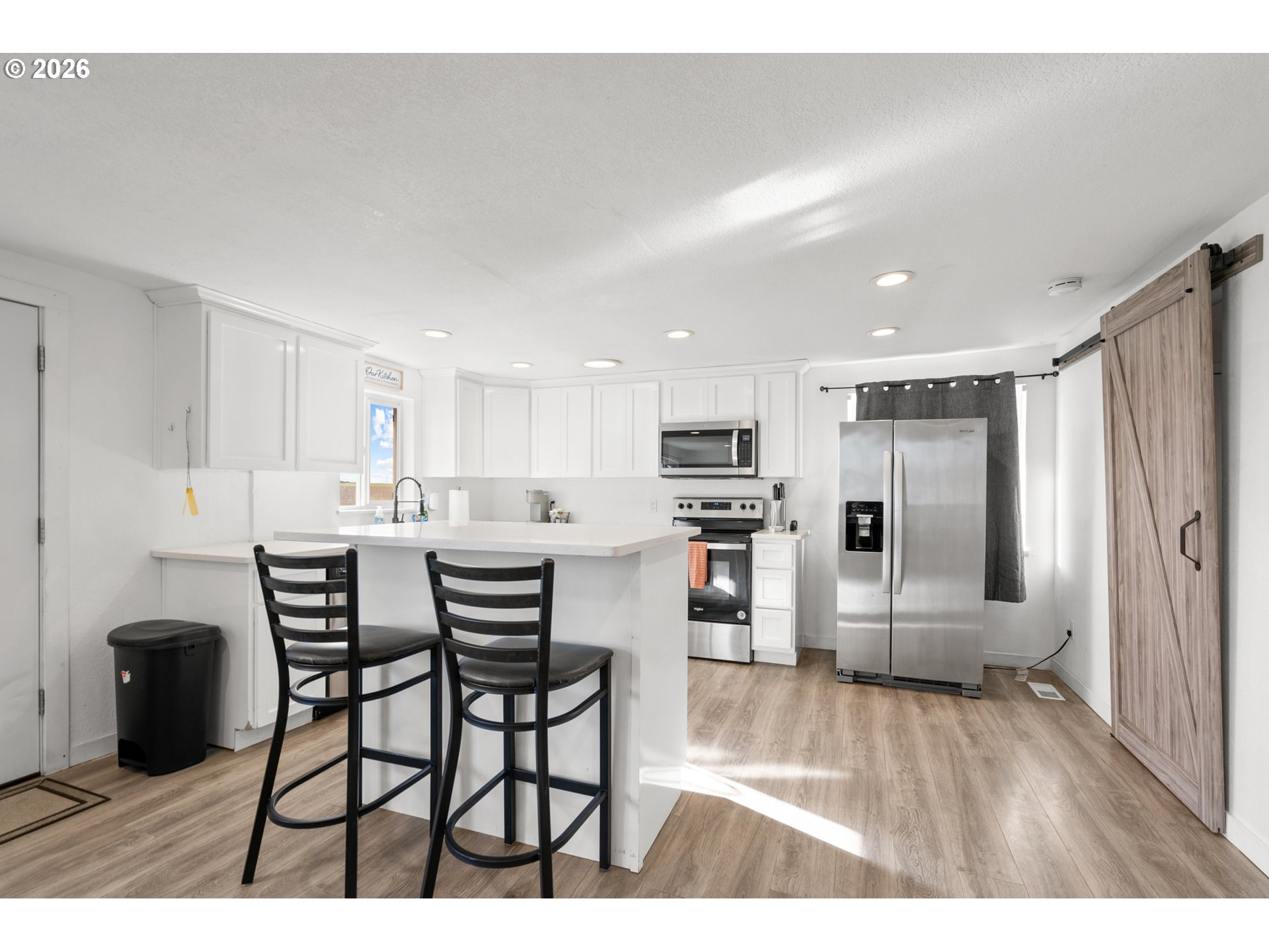 2130 Southeast 19th Street Hermiston, OR 97838 - Photo 6 of 32 a kitchen with stainless steel appliances kitchen island granite countertop a refrigerator and a stove top oven