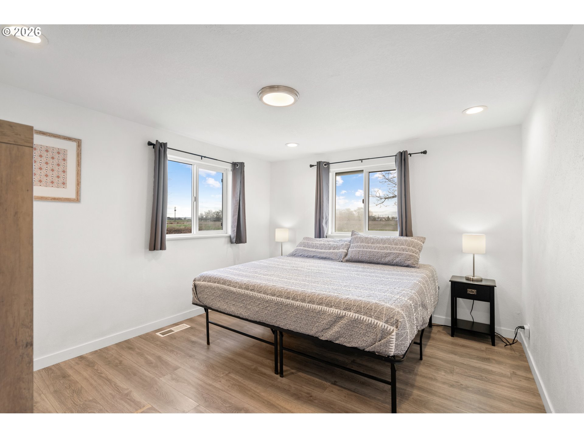 2130 Southeast 19th Street Hermiston, OR 97838 - Photo 7 of 32 a bedroom with a bed window and a night stand