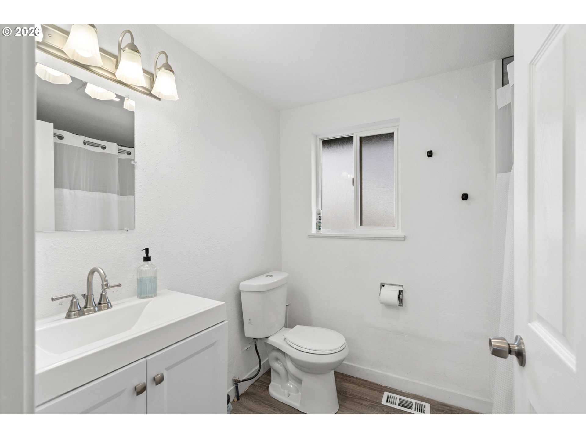 2130 Southeast 19th Street Hermiston, OR 97838 - Photo 9 of 32 a bathroom with a sink a toilet and mirror