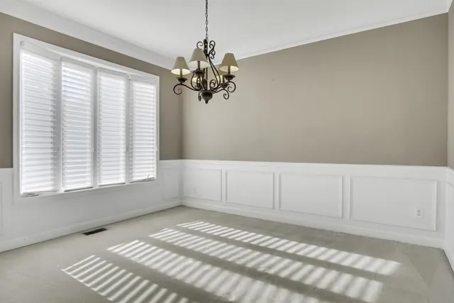 a view of a bedroom with window and ceiling fan