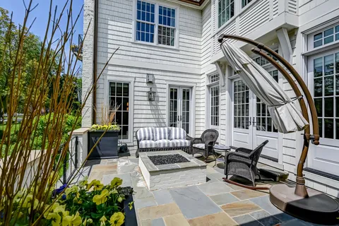 a view of a patio with table and chairs and potted plants
