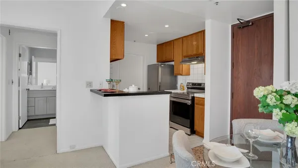 a kitchen with a refrigerator and a sink