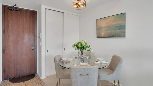a dining room with furniture and potted plant
