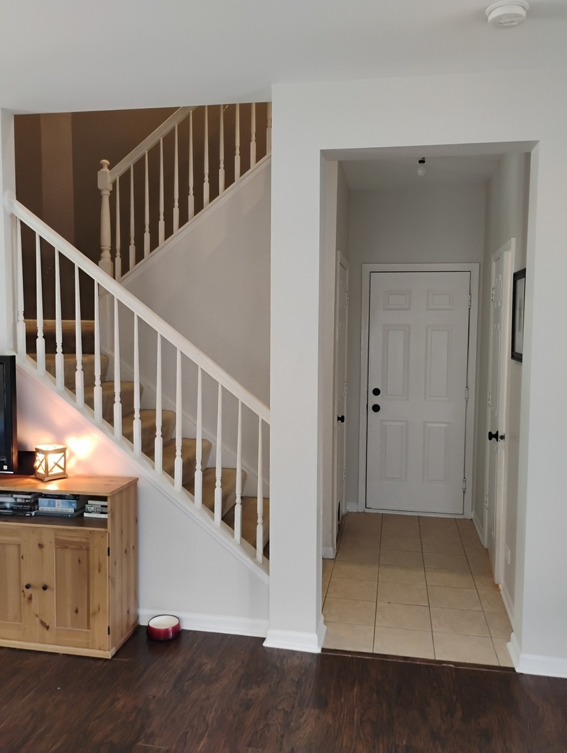 178 West Hampton Drive Round Lake, IL 60073 - Photo 15 of 55 a view of a hallway with entryway wooden floor and front door