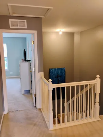 a bedroom with a bed and a tv on the dresser