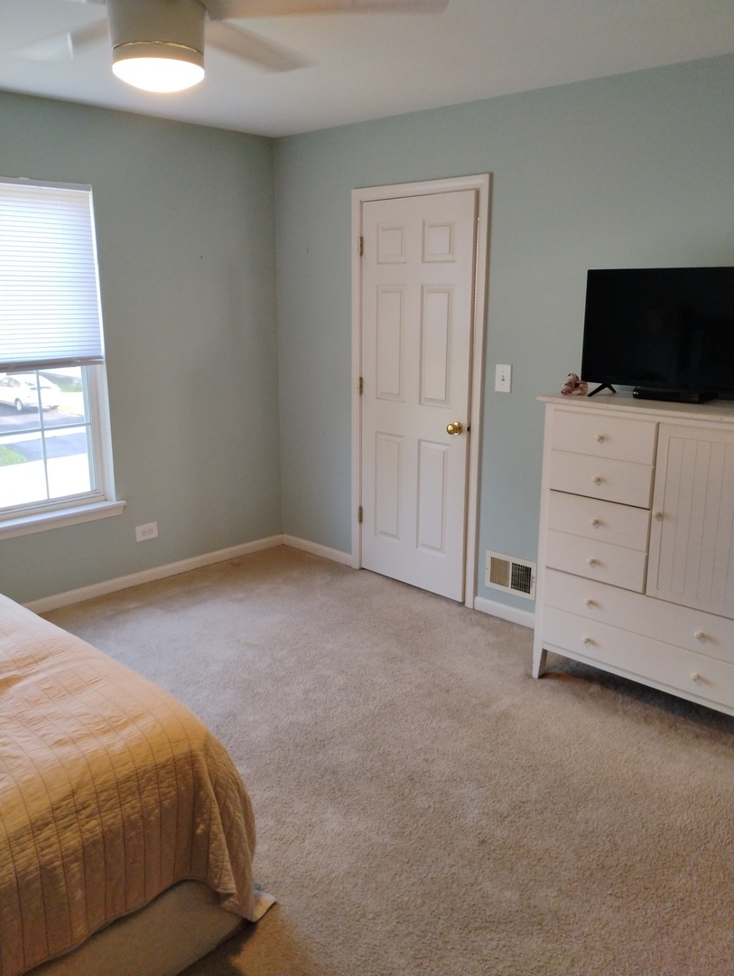178 West Hampton Drive Round Lake, IL 60073 - Photo 25 of 55 a bedroom with a bed and a tv on the dresser