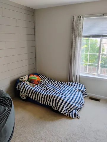 a room with lots of white furniture and a couch