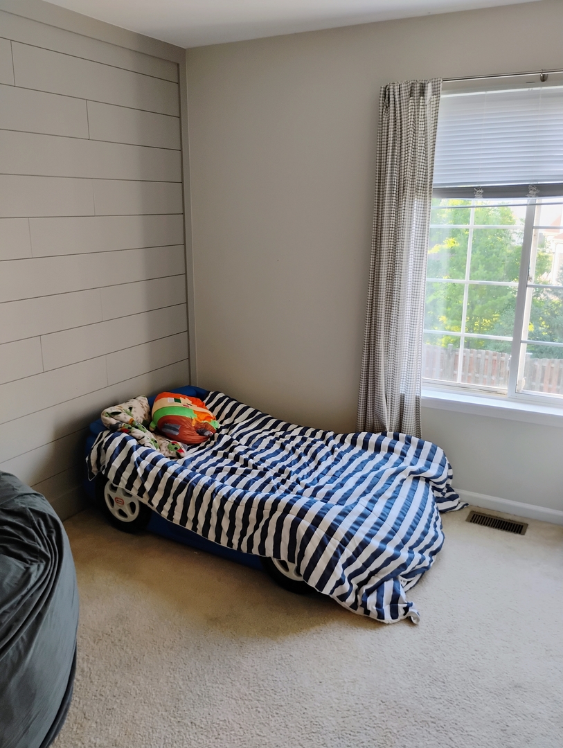 178 West Hampton Drive Round Lake, IL 60073 - Photo 31 of 55 a bed sitting in a bedroom next to a window