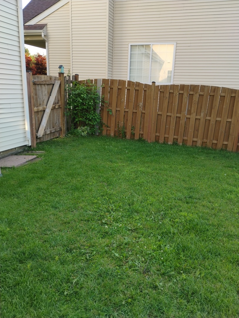 178 West Hampton Drive Round Lake, IL 60073 - Photo 38 of 55 a view of backyard with potted plants and wooden fence