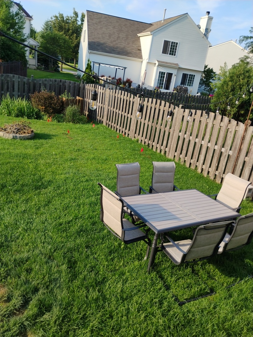 178 West Hampton Drive Round Lake, IL 60073 - Photo 45 of 55 a backyard of a house with table and chairs