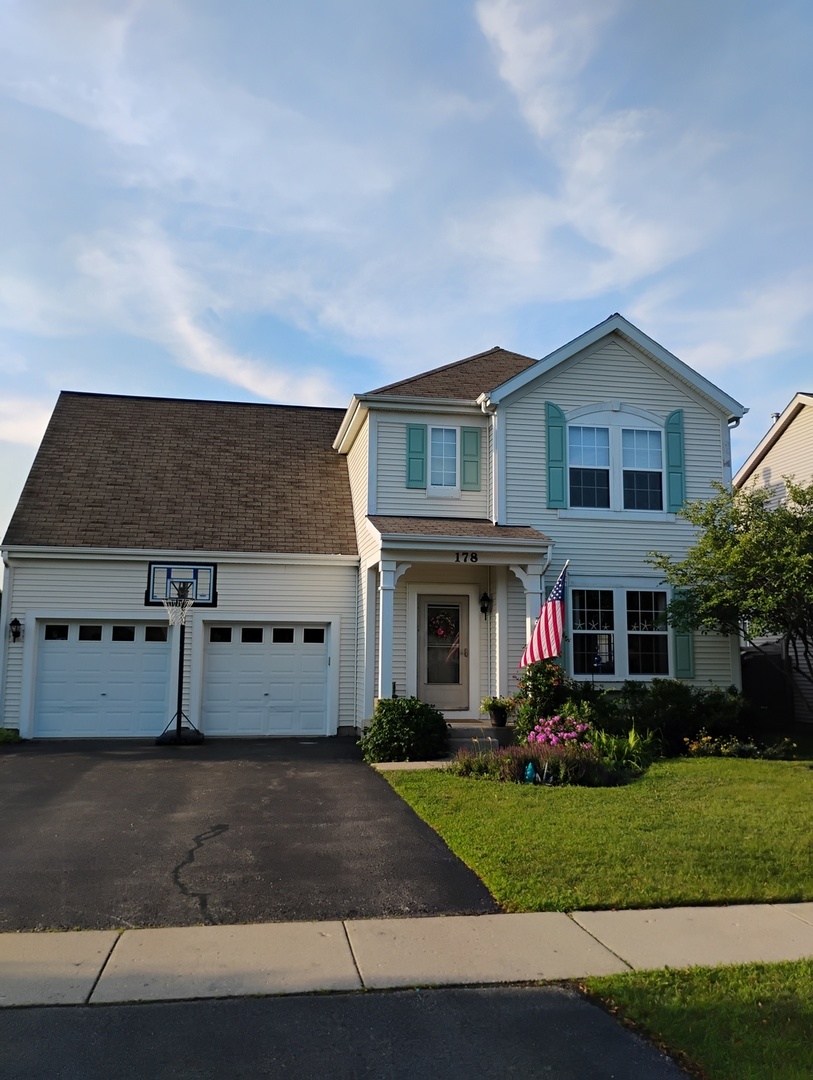 178 West Hampton Drive Round Lake, IL 60073 - Photo 49 of 55 a front view of a house with a yard and garage