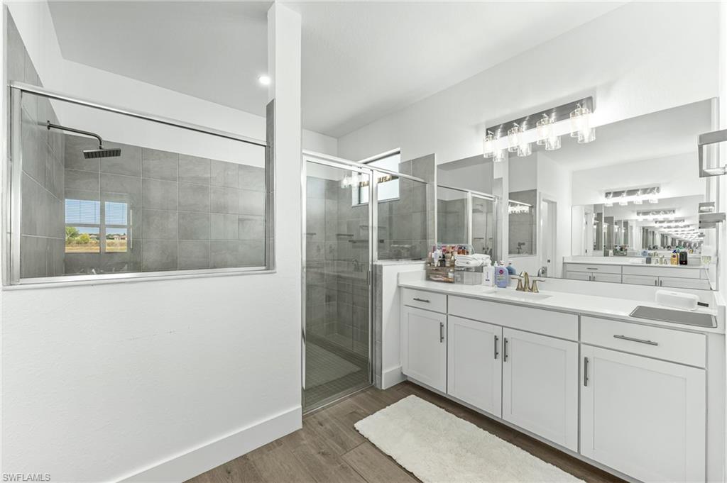 1465 Birdie Drive Naples, FL 34120 - Photo 20 of 38 a bathroom with a double vanity sink mirror and shower