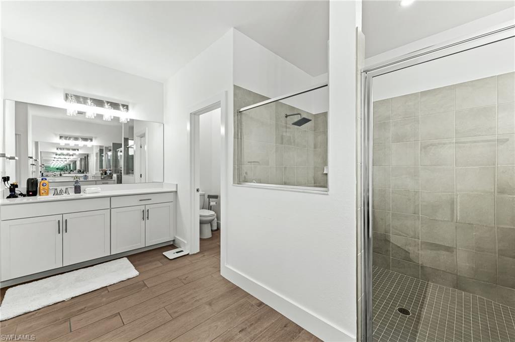 1465 Birdie Drive Naples, FL 34120 - Photo 21 of 38 a large white bathroom with a double vanity sink a mirror and a shower