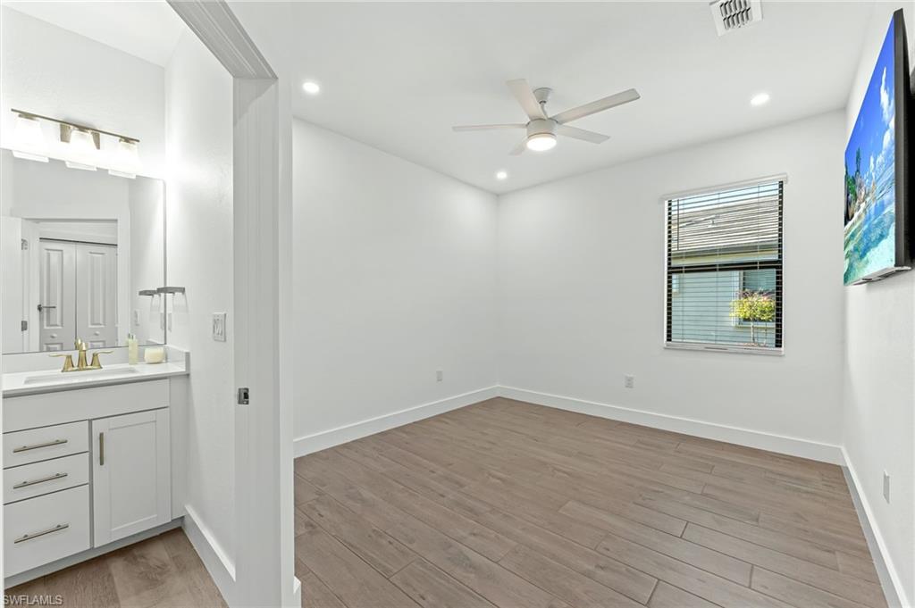 1465 Birdie Drive Naples, FL 34120 - Photo 22 of 38 a view of a kitchen with closet and wooden floor
